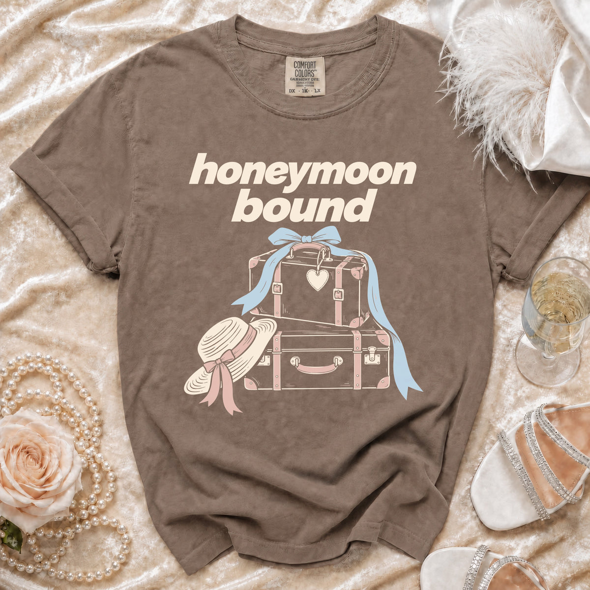 Brown t-shirt with "honeymoon bound" text and vintage luggage graphic.