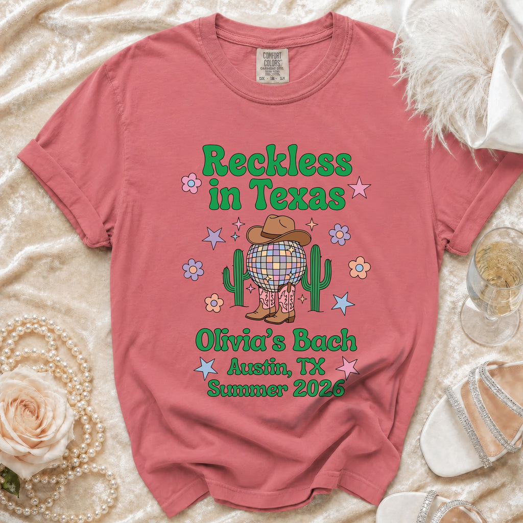 Distressed graphic tee with "Reckless in Texas Olivia's Bach Austin, TX Summer 2026" text.