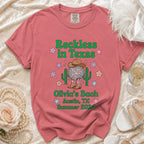 Distressed graphic tee with "Reckless in Texas Olivia's Bach Austin, TX Summer 2026" text.