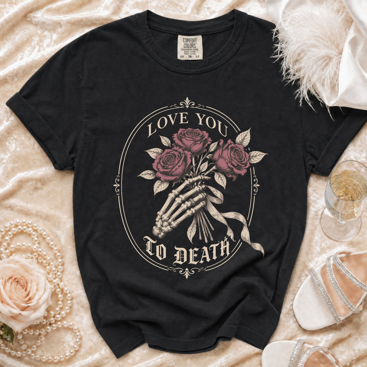 Black t-shirt with skeleton hand holding roses and text "LOVE YOU TO DEATH."