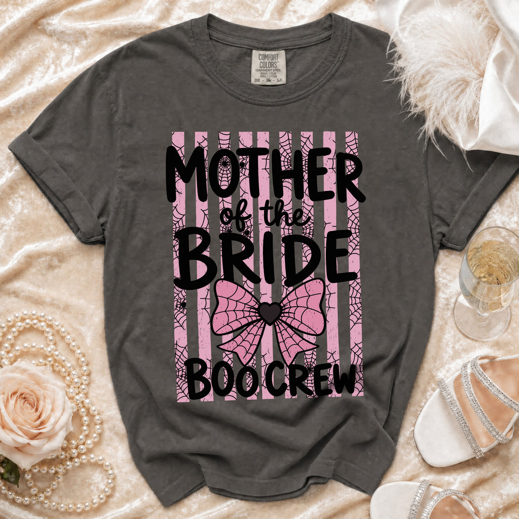 A dark gray t-shirt featuring pink and black text that reads Mother of the Bride Boo Crew.