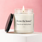 Lit candle in glass jar with "Do me the honor? Please be my maid of honor." text.