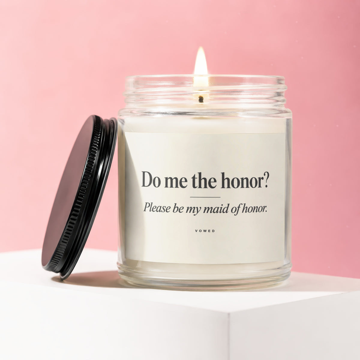 Lit candle in glass jar with "Do me the honor? Please be my maid of honor." text.