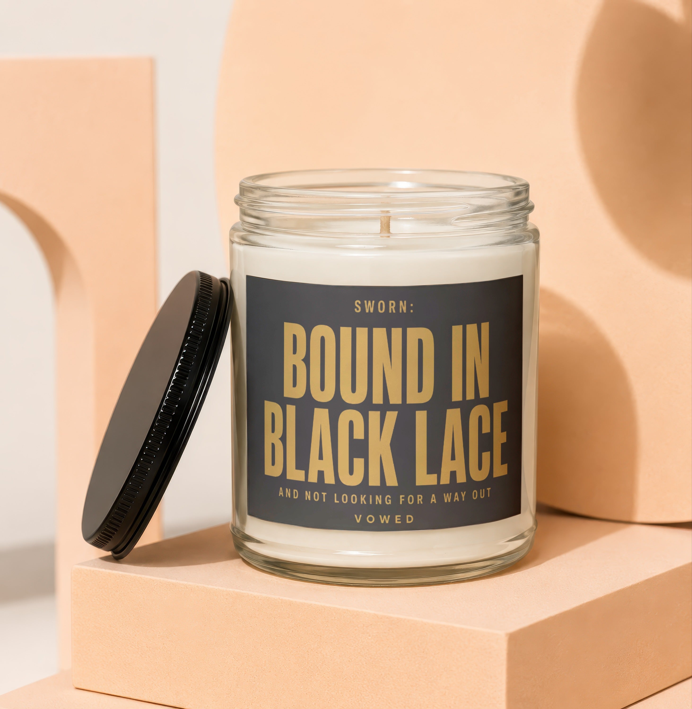 Glass candle with black lid, labeled "SWORN: BOUND IN BLACK LACE"
