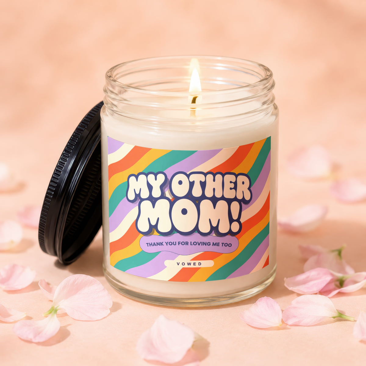 Candle with "My Other Mom" and rainbow design, lit flame.