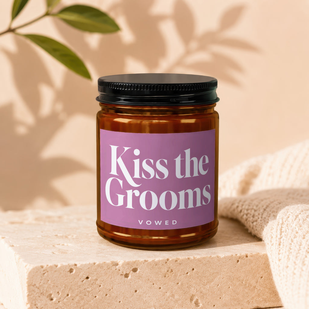 Jar candle with "Kiss the Grooms" and "VOWED" text on a pink label.