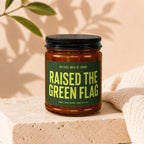 Candle with "Raised the Green Flag Official Maid of Honor" text on a dark green label.