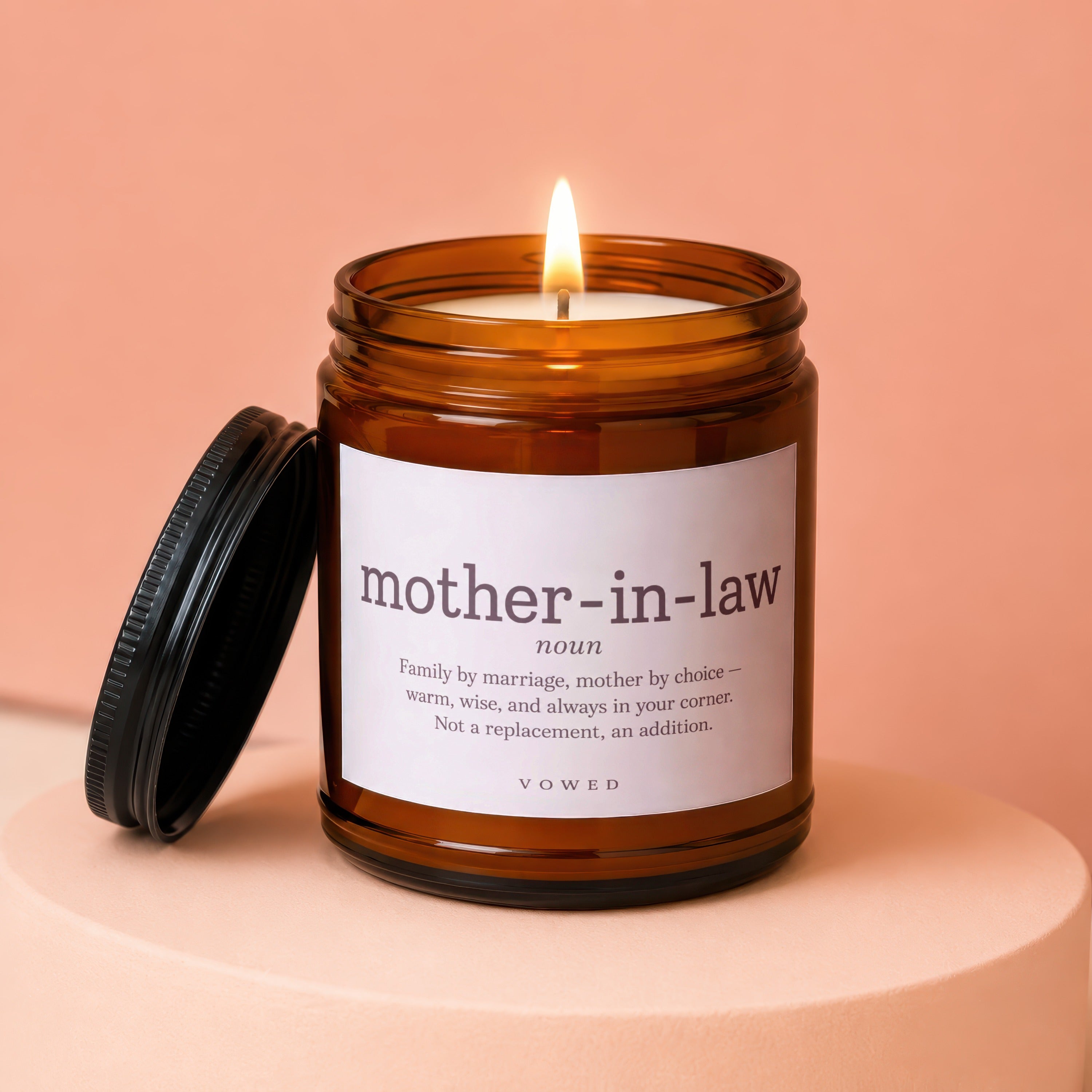 Lit candle in amber jar with "mother-in-law" definition label.