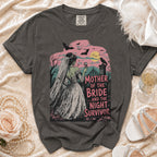 Dark gray t-shirt featuring a green zombie bride in a veil holding a glass, with text reading MOTHER OF THE BRIDE AND THE NIGHT SURVIVOR.