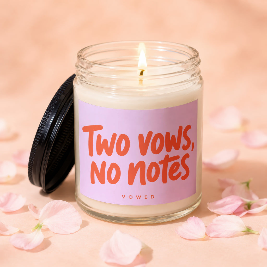 Jar candle with pink label reading "Two vows, no notes" and "vowed".