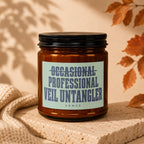 Amber jar candle with label reading "OCCASIONAL PROFESSIONAL VEIL UNTANGLER".