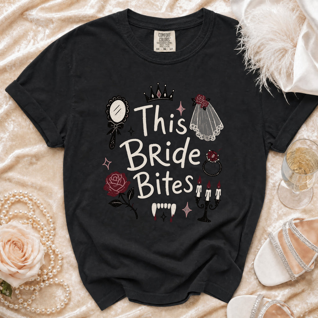 Black t-shirt with "This Bride Bites" graphic featuring vampire fangs and wedding elements.