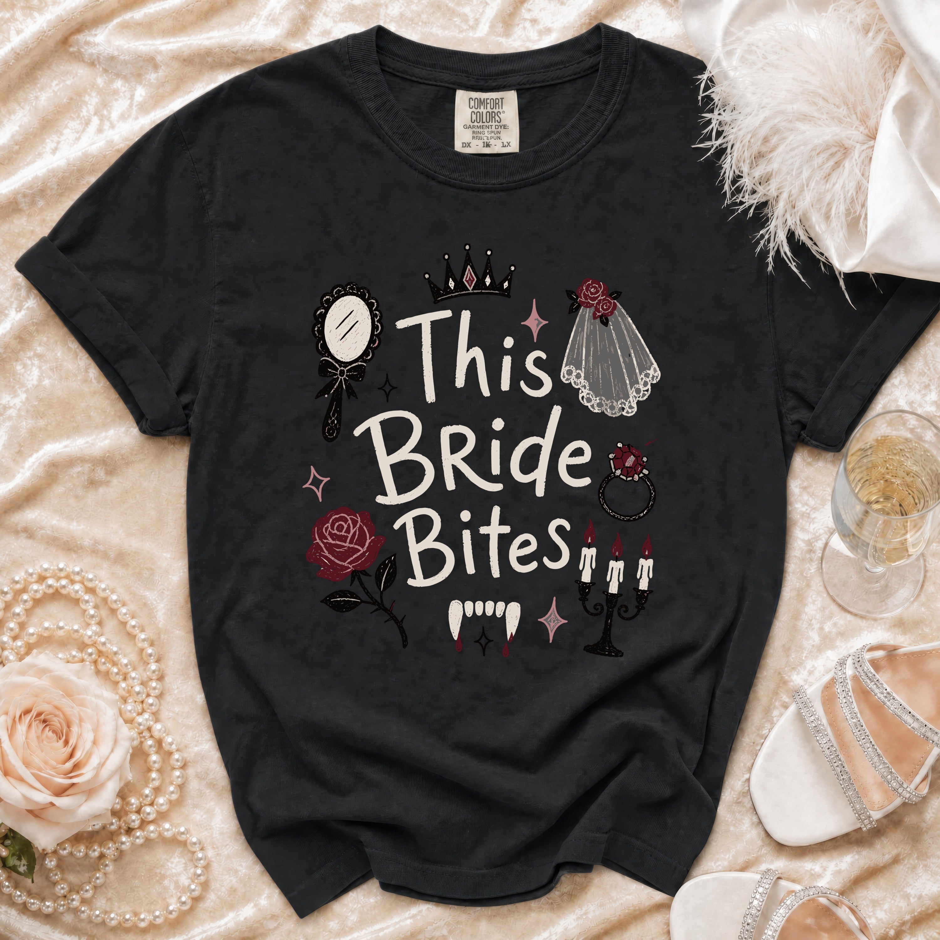 Black t-shirt with "This Bride Bites" graphic featuring vampire fangs and wedding elements.