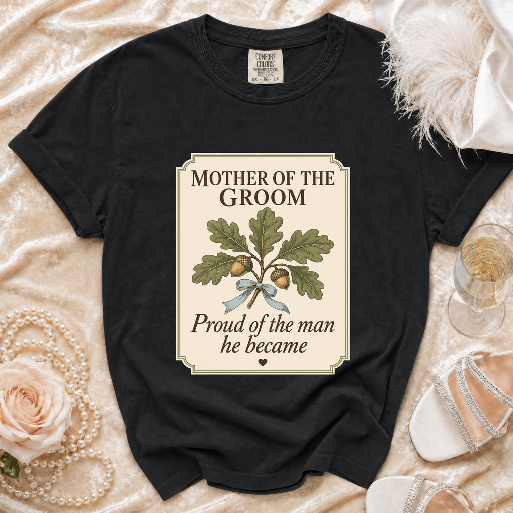 Black t-shirt with "Mother of the Groom Proud of the man he became" graphic.