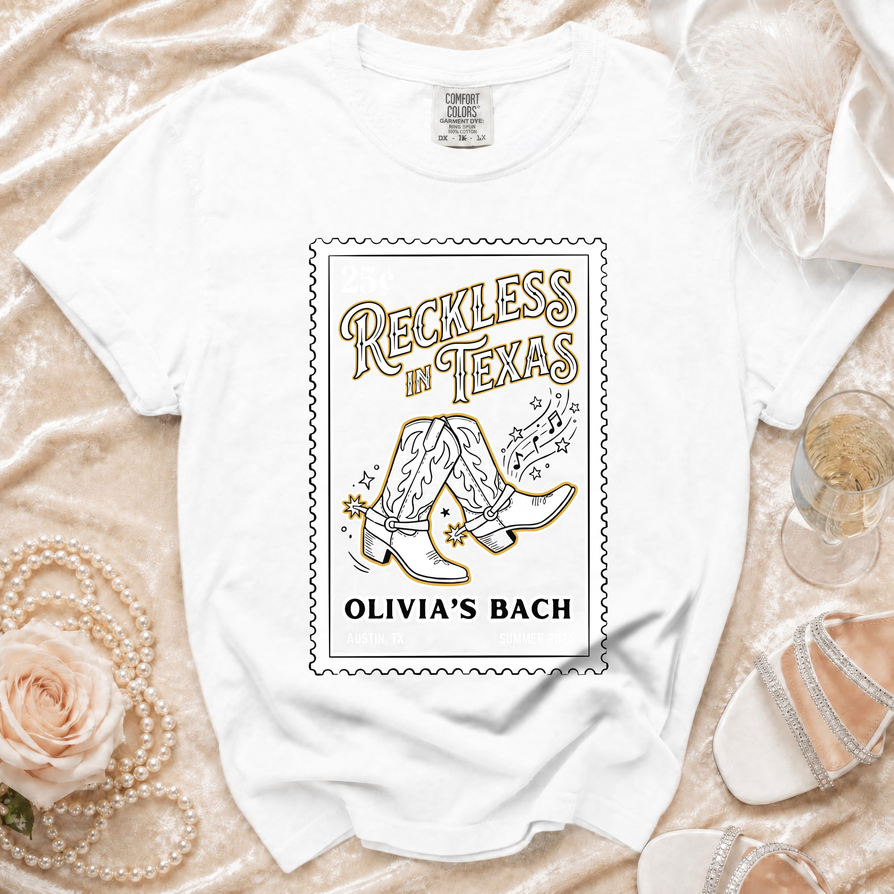 White t-shirt with "Reckless in Texas" and cowboy boots graphic.