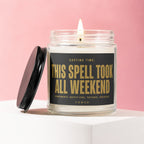Glass candle with flame, black lid askew. Label reads: "THIS SPELL TOOK ALL WEEKEND".