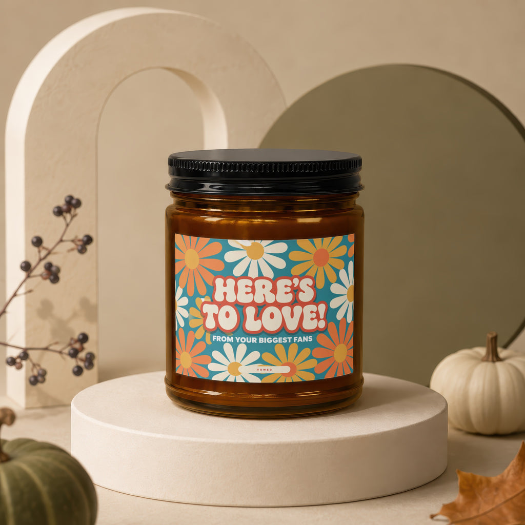 Amber glass candle with "HERE'S TO LOVE! FROM YOUR BIGGEST FANS" label.