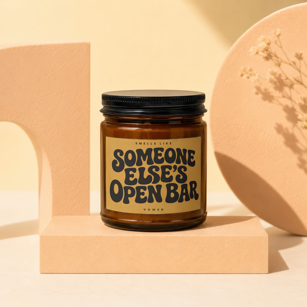 Brown candle with black lid and "Someone Else's Open Bar" label.