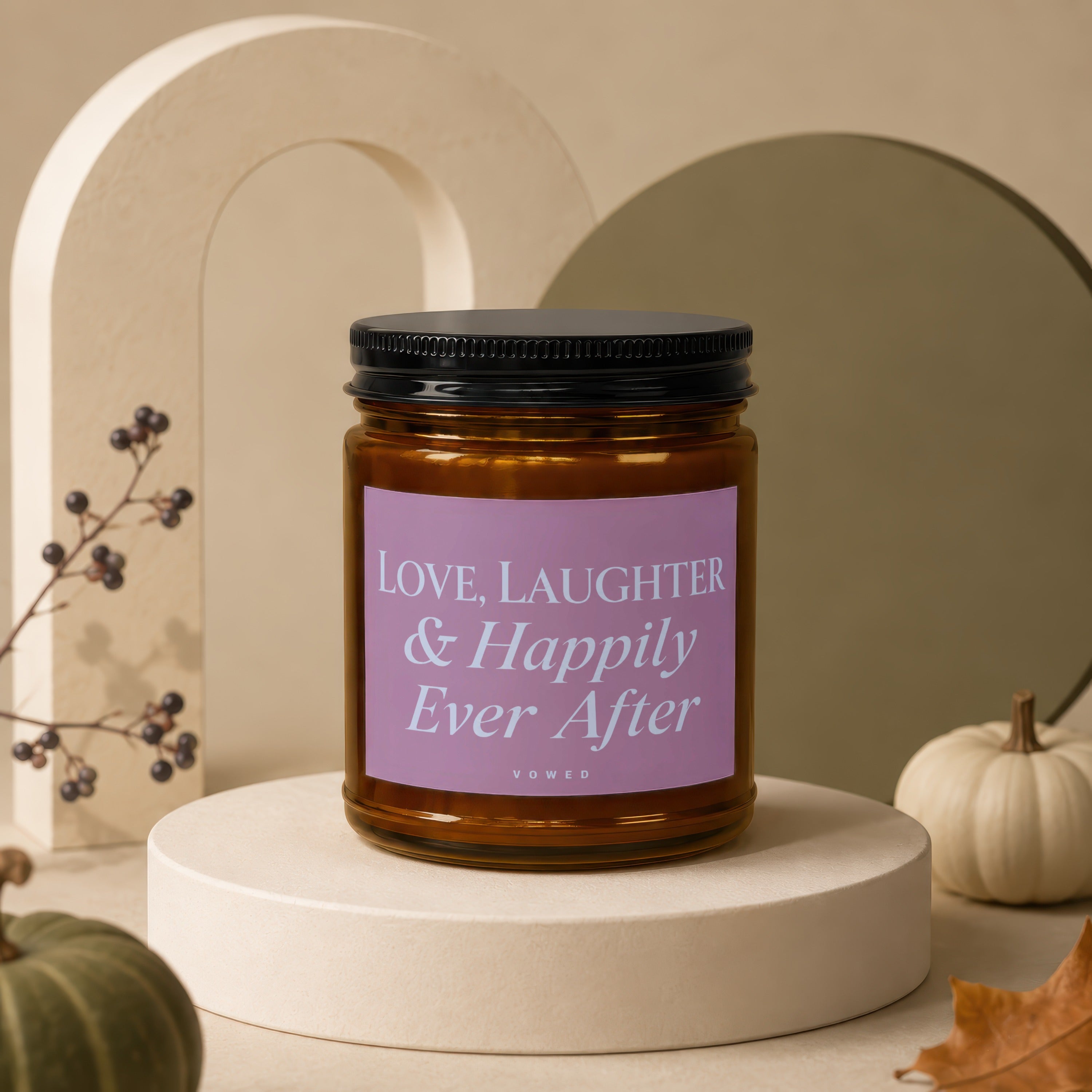 Glass candle with label saying "LOVE, LAUGHTER & Happily Ever After" below a decorative arch.