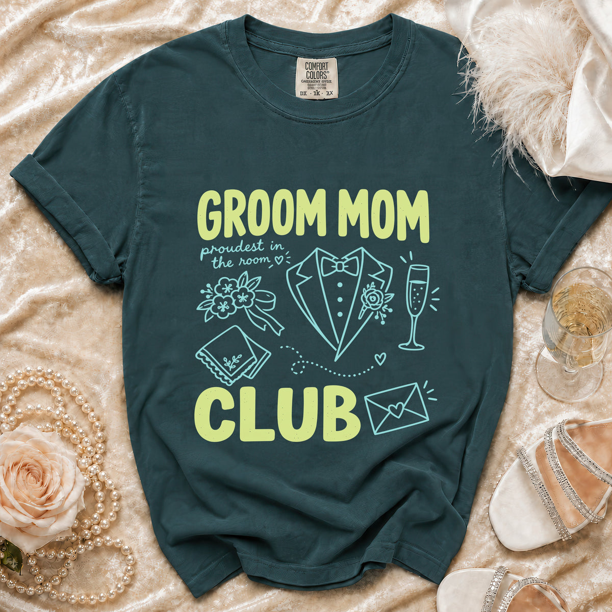 Dark teal t-shirt with "Groom Mom Club" text and wedding icons.