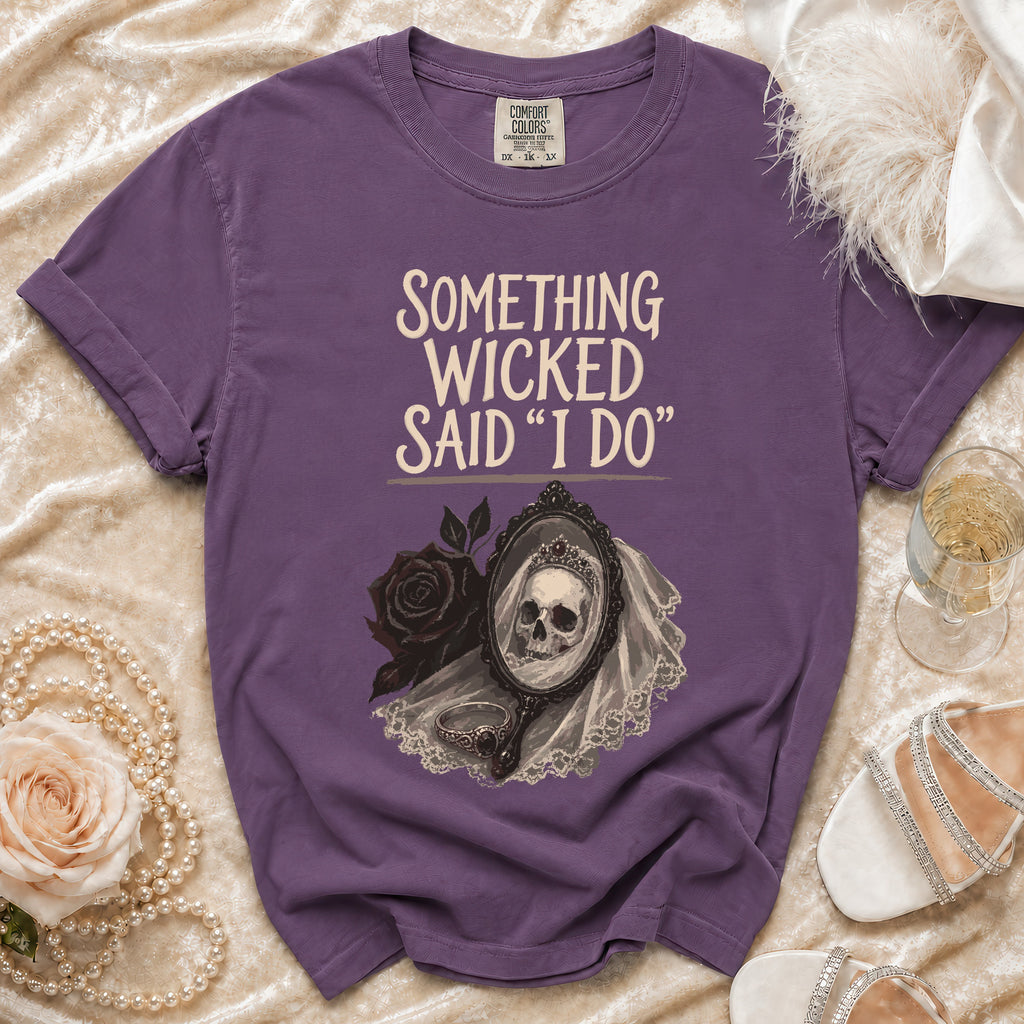 Purple t-shirt with "Something Wicked Said I Do" graphic and skull bride in mirror.