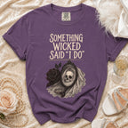 Purple t-shirt with "Something Wicked Said I Do" graphic and skull bride in mirror.