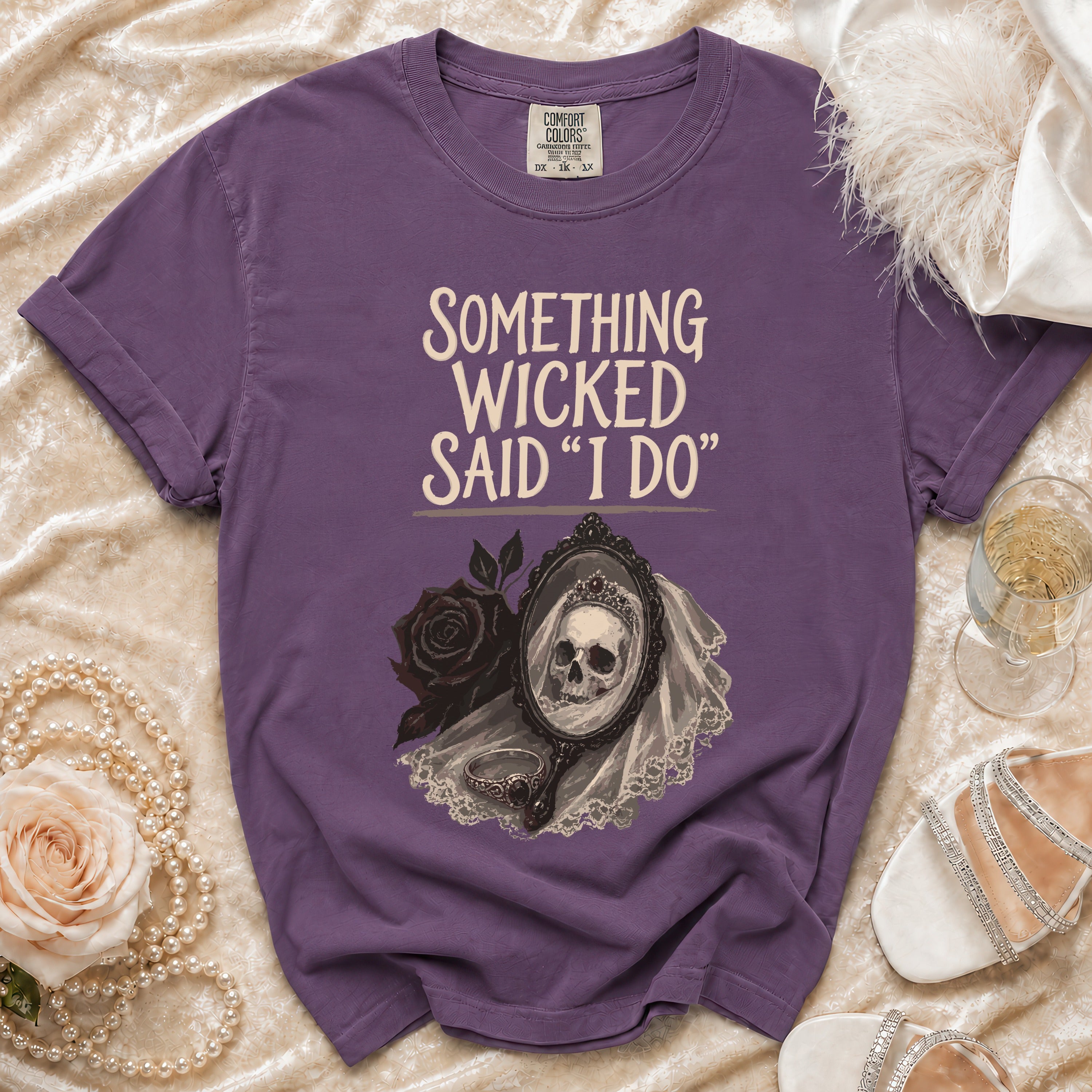 Purple t-shirt with "Something Wicked Said I Do" graphic and skull bride in mirror.