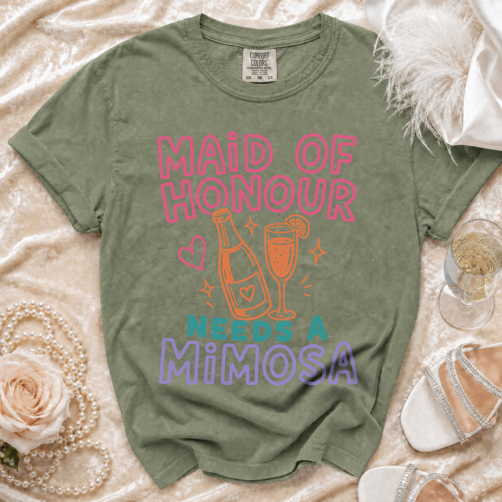 Olive green t-shirt with "Maid of Honour Needs a Mimosa" text and drink graphic.