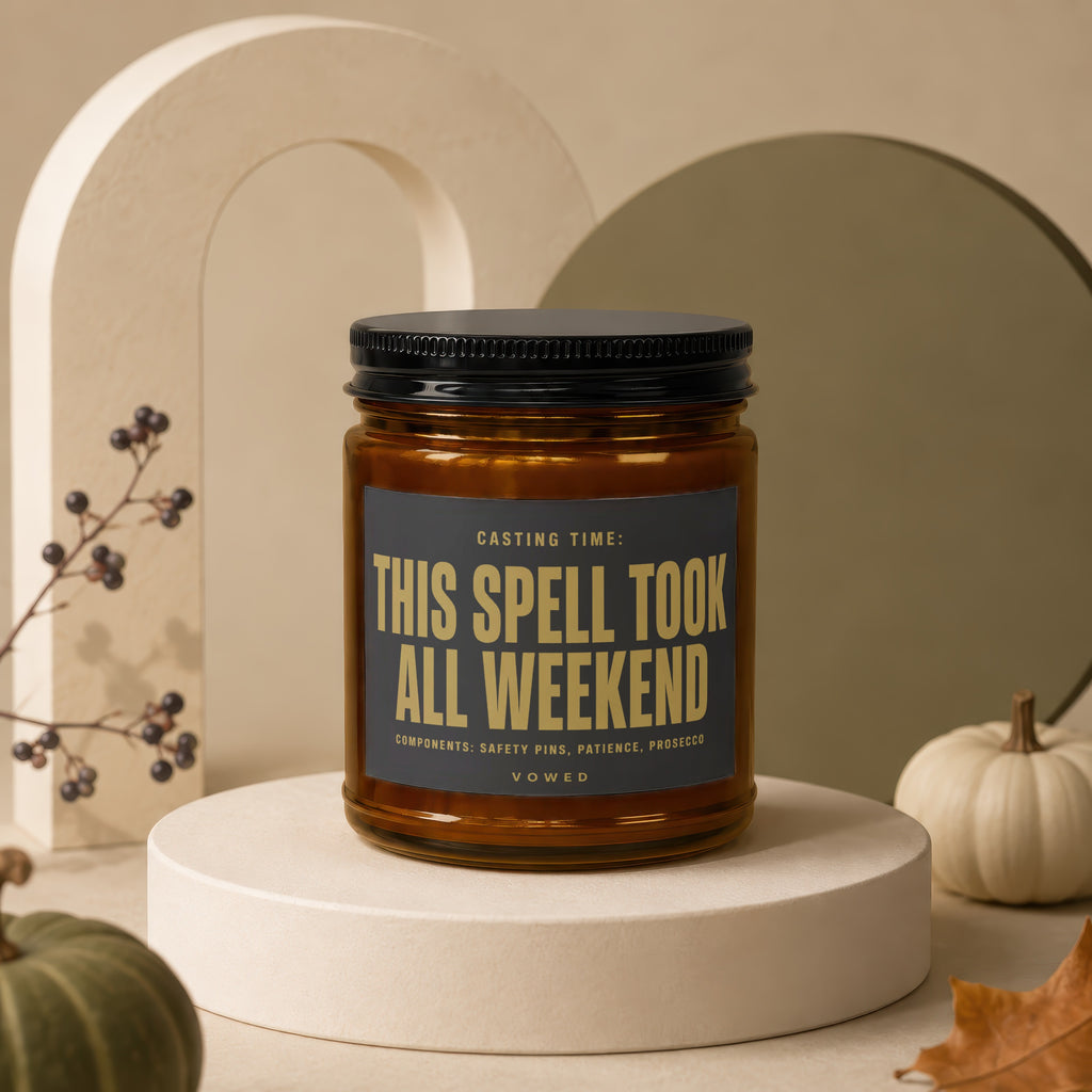 Amber jar candle with black lid, reads "This Spell Took All Weekend".