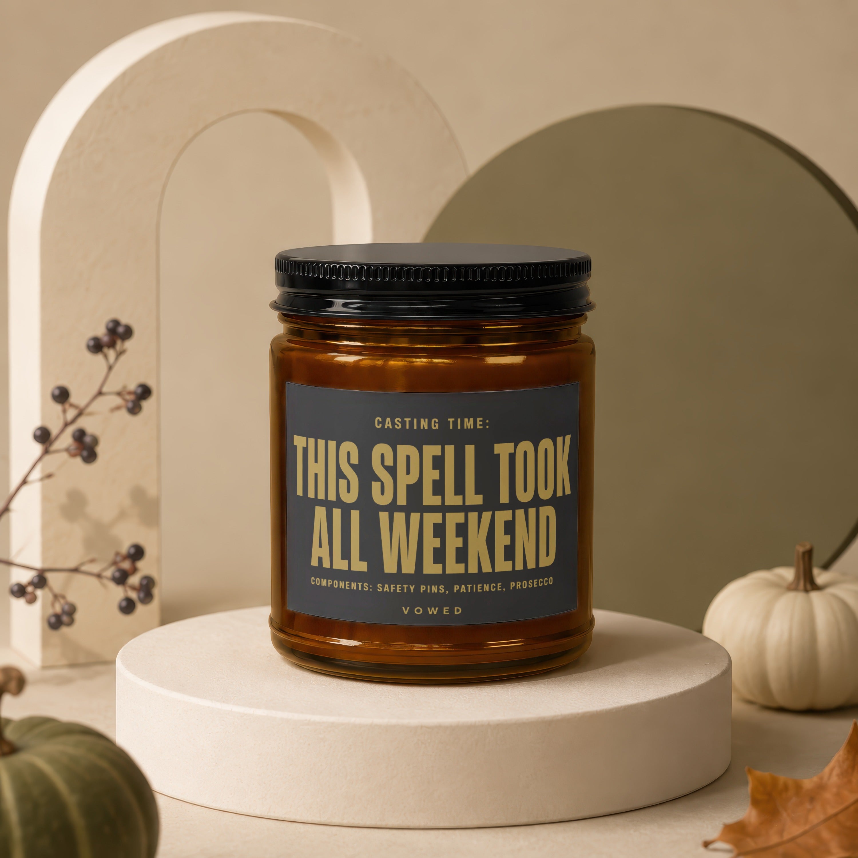 Amber jar candle with black lid, reads "This Spell Took All Weekend".