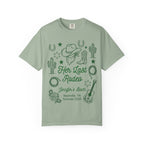 Green t-shirt with "Her Last Rodeo" text and Western graphics.