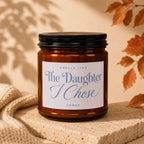 Amber candle with black lid labeled "Smells Like The Daughter I Chose Vowed".