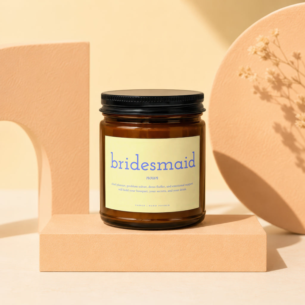 Brown jar candle with "bridesmaid noun" label and descriptive text.