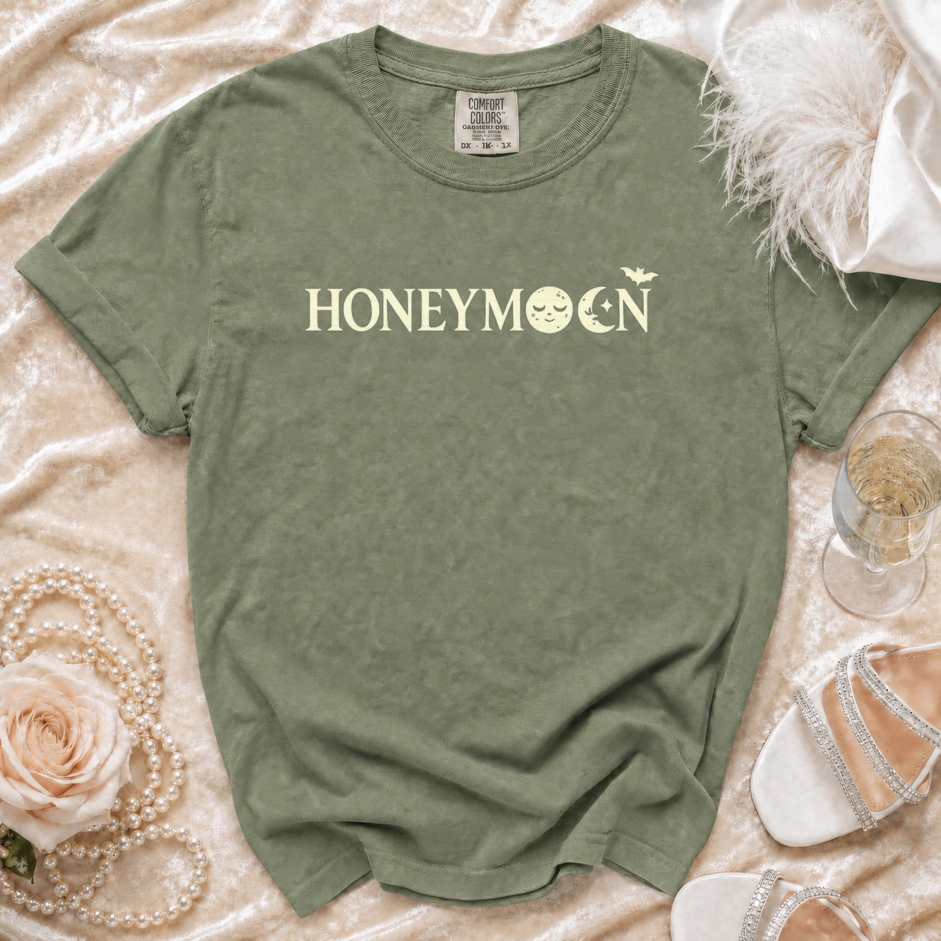 Green t-shirt with "HONEYMOON" text featuring moons and a bat graphic.