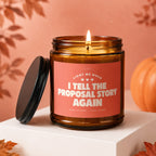 Amber candle with pink label reading "Light Me When I Tell The Proposal Story Again".