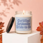Candle labeled "Certified Bridezilla Bride-to-Be" with lid off.