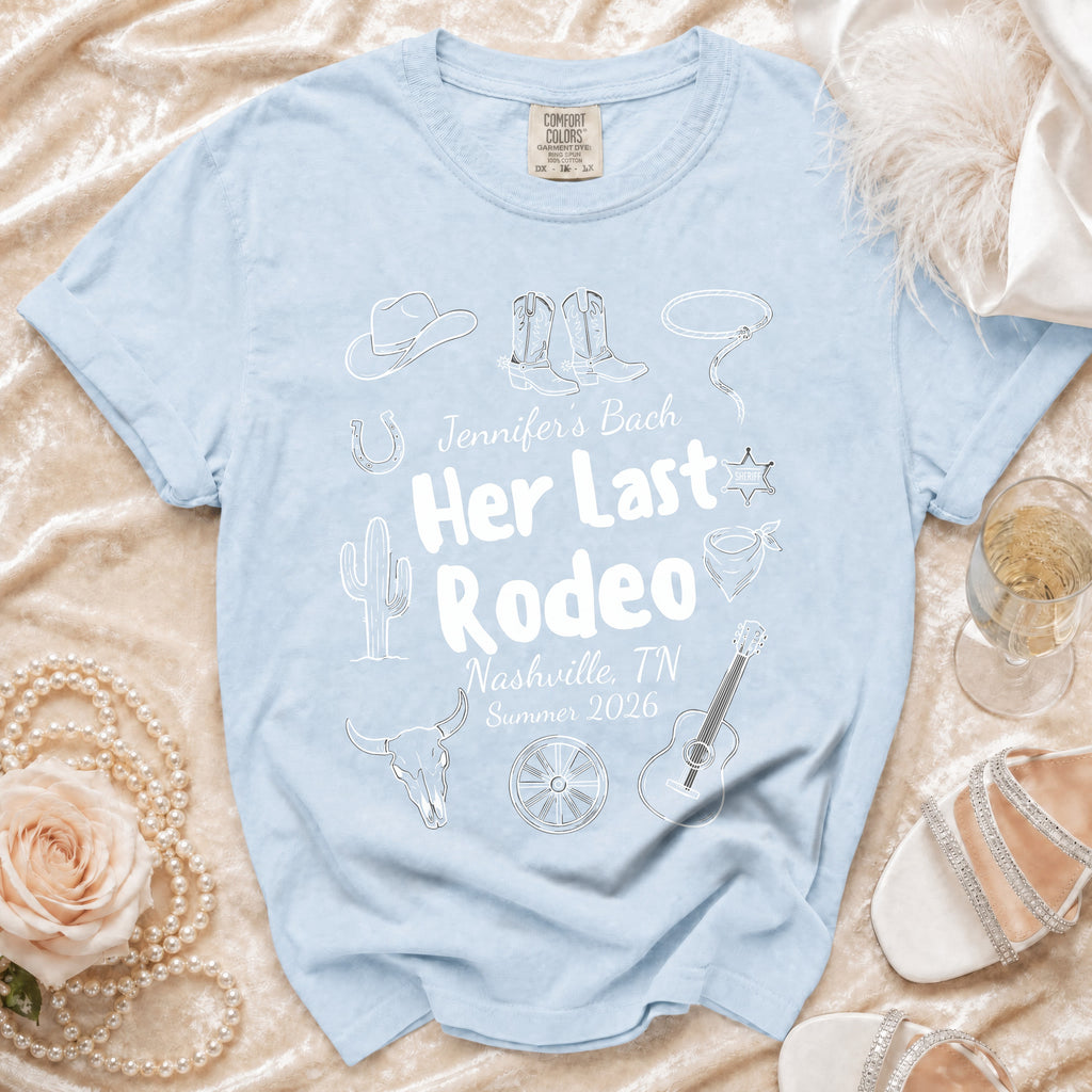 Light blue t-shirt with "Jennifer's Bach Her Last Rodeo Nashville, TN Summer 2026" text and rodeo graphics.