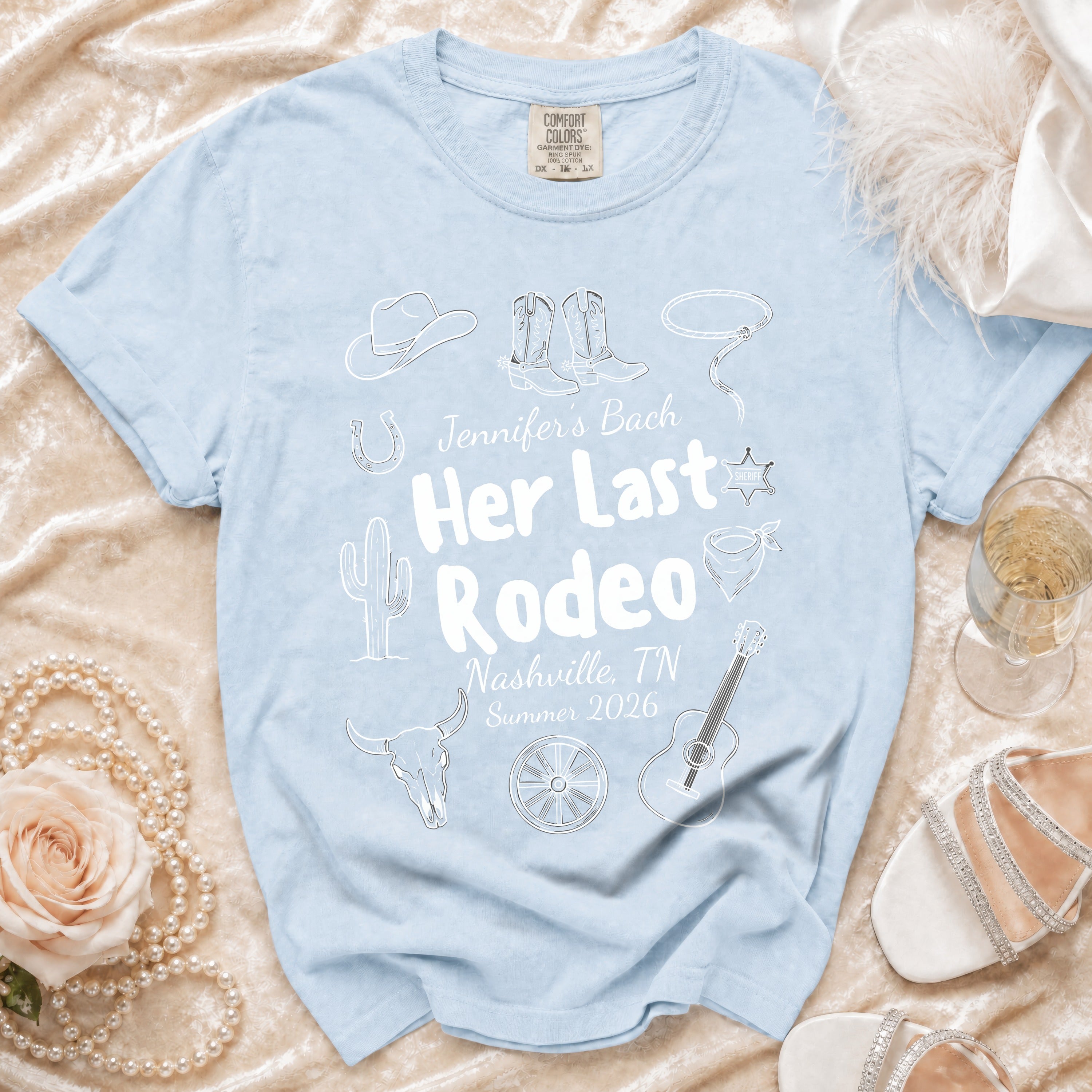 Light blue t-shirt with "Jennifer's Bach Her Last Rodeo Nashville, TN Summer 2026" text and rodeo graphics.