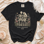 Black t-shirt with skeleton couple illustration and "STILL CHOOSING YOU" text.