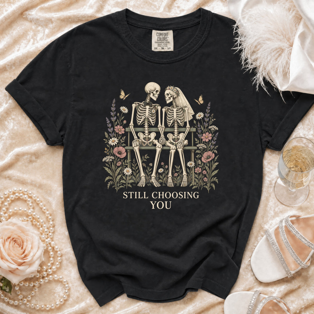 Black t-shirt with skeleton couple illustration and "STILL CHOOSING YOU" text.