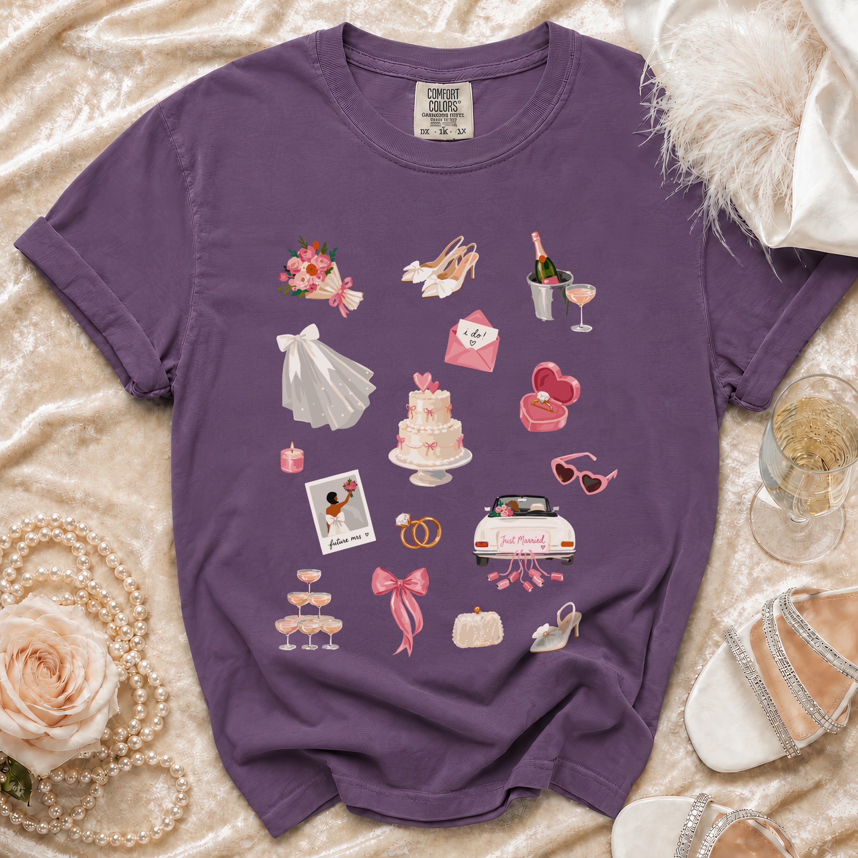 Purple t-shirt with wedding-themed graphics including a cake, rings, and "Just Married" car.
