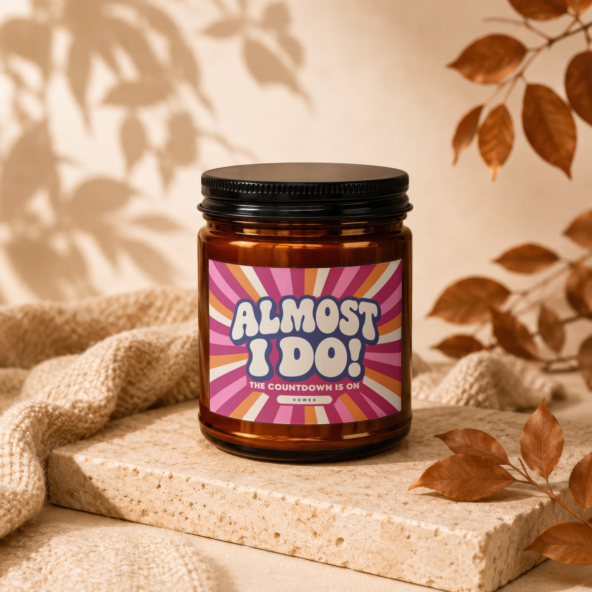 Amber candle with a colorful label reading "Almost I Do! The Countdown Is On Vowed".