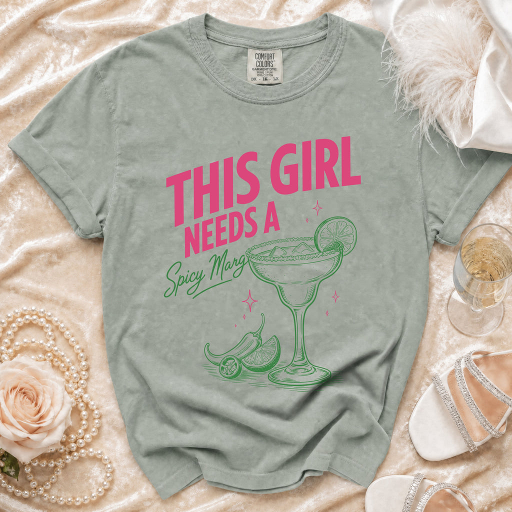 Green t-shirt with "This girl needs a spicy marg" and margarita graphic.