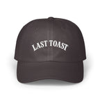 Dark gray baseball cap with "LAST TOAST" embroidered in white lettering.