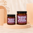 Two amber jars with black lids, both labeled "Two grooms, no bride, no problem."