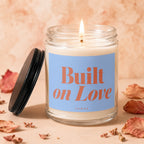 Candle with blue label reading "Built on Love" and "Vowed".