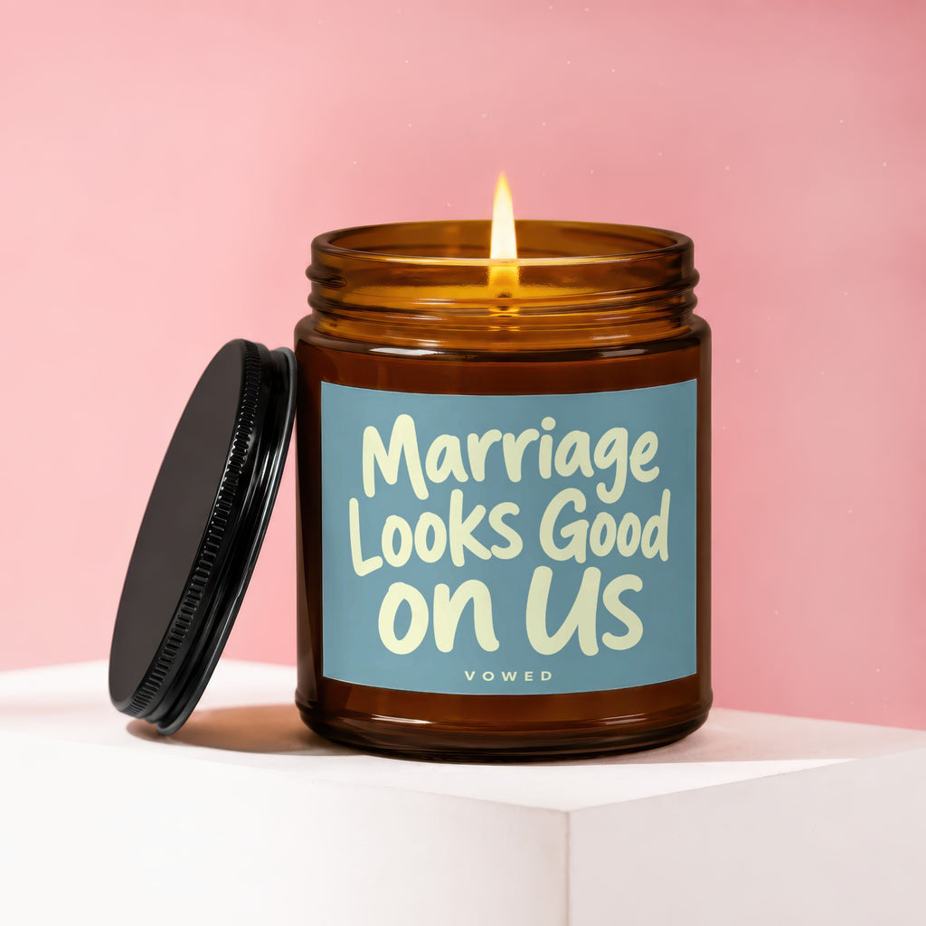 Amber jar candle with lit flame, "Marriage Looks Good on Us" text label.