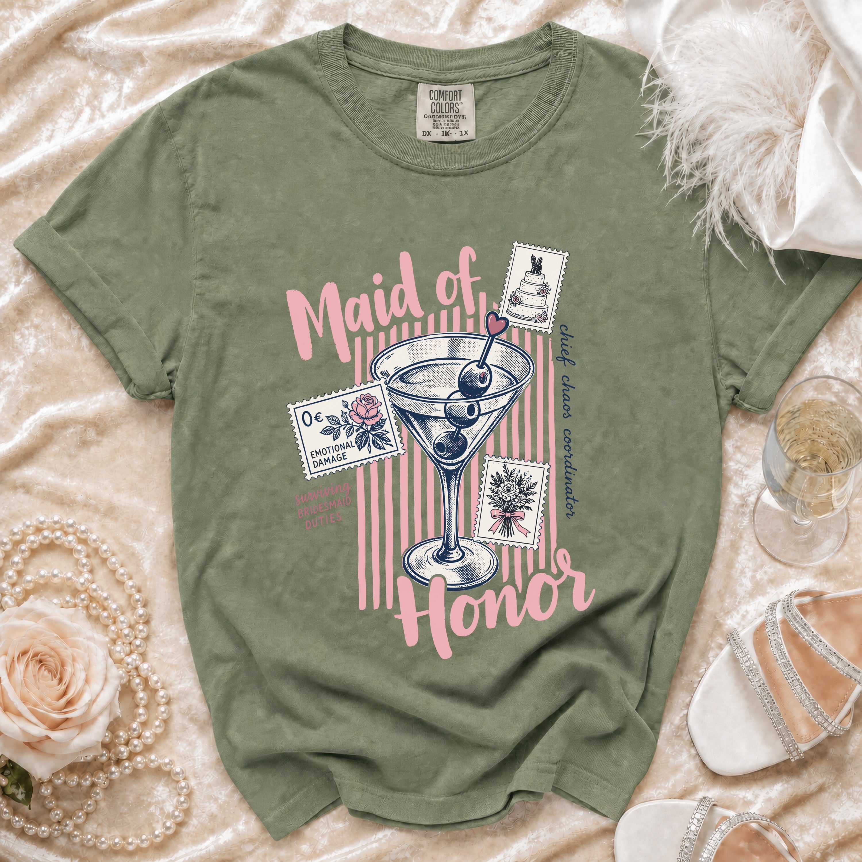 Green t-shirt with pink text "Maid of Honor" and martini glass graphic.