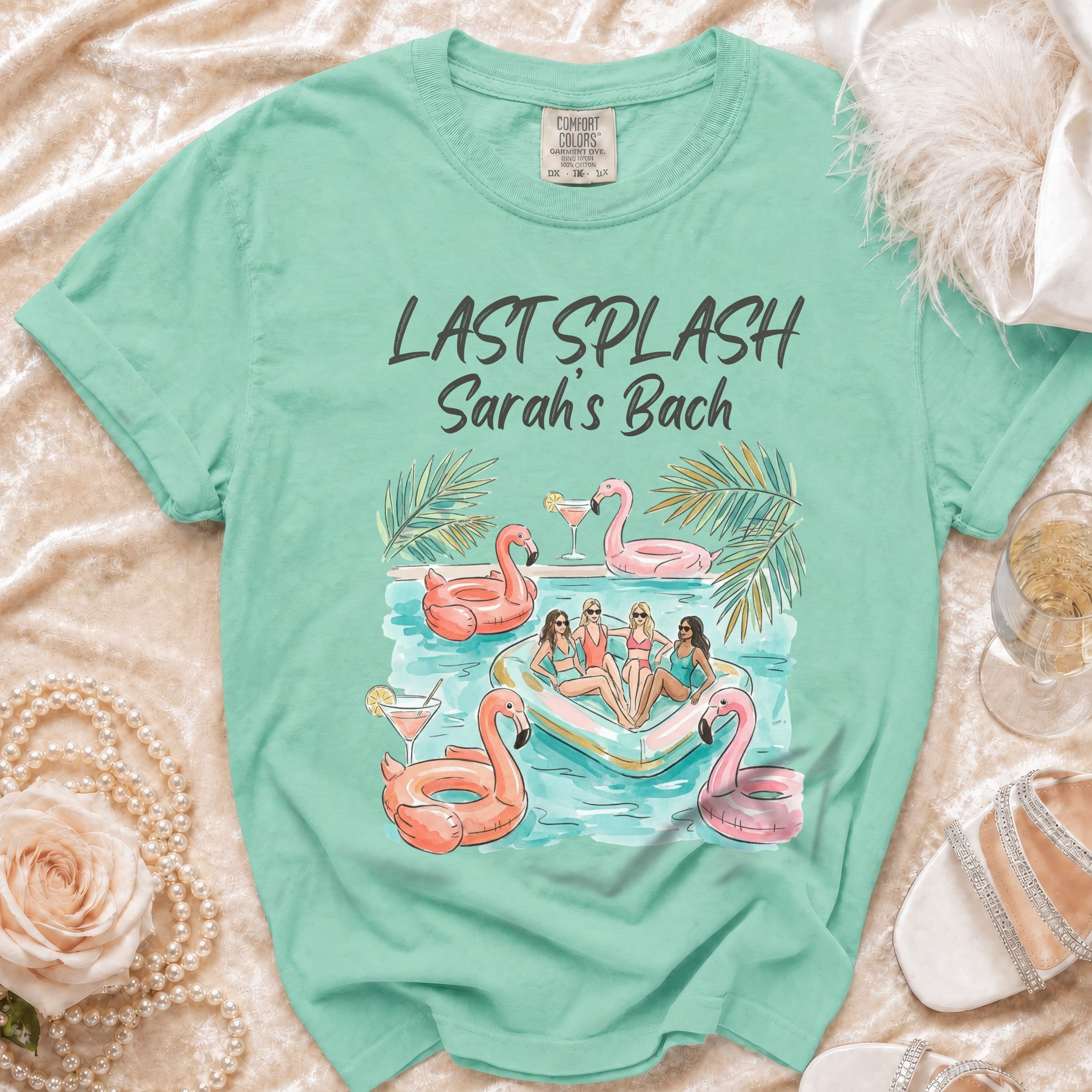 Mint green t-shirt with Sarah's Splash bachelorette graphic featuring pool float and flamingos.