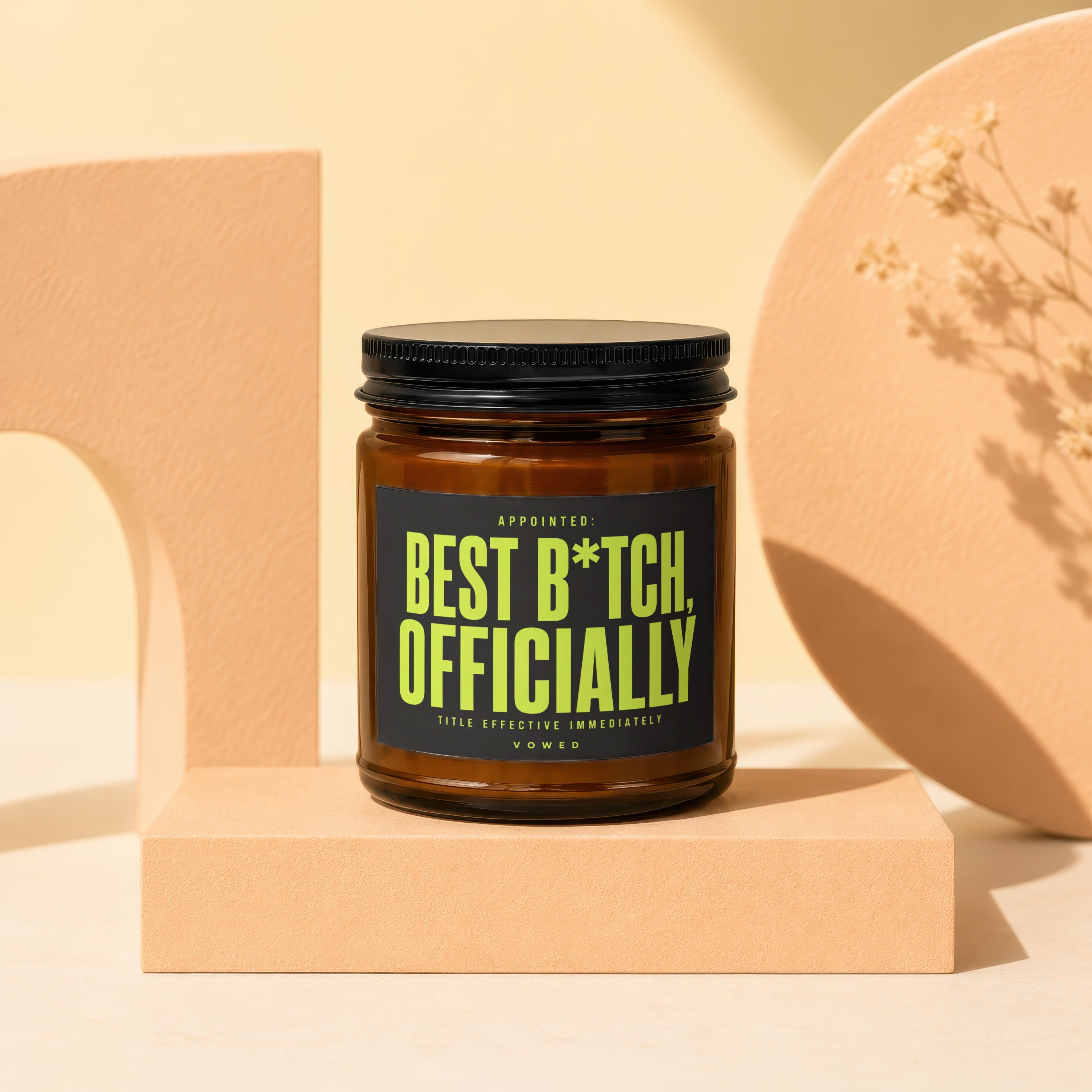 Brown candle with black lid and label reading "Appointed: Best B*tch, Officially."